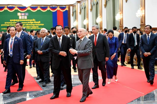 Cambodia's King Norodom Sihamoni (center R) walks with Cambodian Senate President Hun Sen (centre L) as they visit the new Senate building, known as Solidarity Palace, during its inauguration ceremony in Phnom Penh on August 21, 2026. (Photo by TANG CHHIN Sothy / AFP)