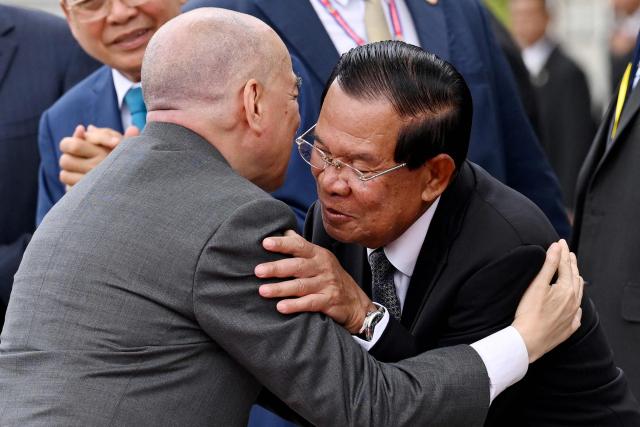 Cambodia's King Norodom Sihamoni (L) hugs Cambodian Senate President Hun Sen (R) after the inauguration ceremony of the new Senate building, known as Solidarity Palace, in Phnom Penh on August 21, 2026. (Photo by TANG CHHIN Sothy / AFP)