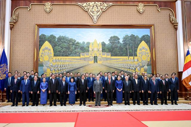 Cambodia's King Norodom Sihamoni (C), Cambodian Senate President Hun Sen (centre L) and senators and government officials pose for a picture during the inauguration ceremony of the new Senate building, known as Solidarity Palace, in Phnom Penh on August 21, 2026. (Photo by TANG CHHIN Sothy / AFP)