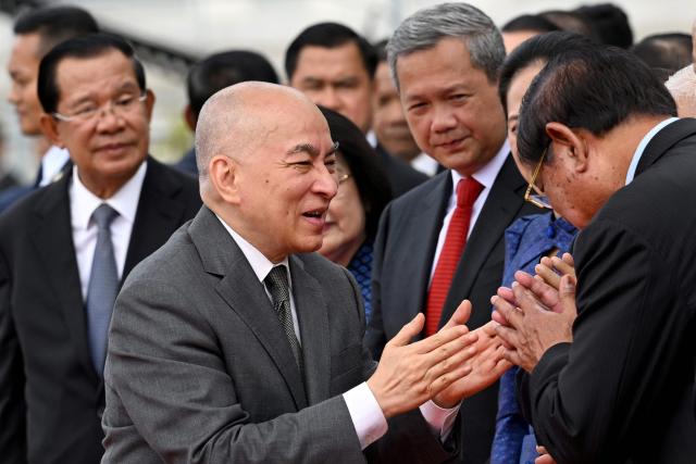 Cambodia's King Norodom Sihamoni (C) greets government officials after the inauguration ceremony of the new Senate building, known as Solidarity Palace, in Phnom Penh on August 21, 2026. (Photo by TANG CHHIN Sothy / AFP)