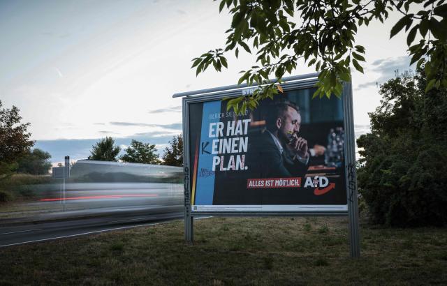 An election poster (L) of the far-right Alternative for Germany (AfD) party is alteres with a graffiti that reads 3He has no plan" is pictured in Magdeburg, eastern Germany, on August 20, 2026. Regional elections in the eastern federal state of Saxony-Anhalt will take place on September 6, 2026. (Photo by Ronny HARTMANN / AFP)