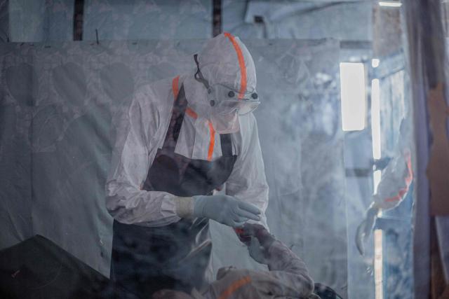 (FILES) A doctor provides care to a patient with Ebola virus disease at the Rwampara Ebola Treatment Centre (ETC) in Bunia, Ituri, in the east of the Democratic Republic of Congo on July 13, 2026. The Ebola outbreak raging in the Democratic Republic of Congo is growing "exponentially", the United Nations' senior Ebola coordinator warned on August 21, 2026. The Ebola outbreak is already the biggest in the country's history having killed more than 2,300 people from more than 5,000 cases, according to the African Union health agency. The virus eruption is "growing exponentially," United Nations' senior Ebola coordinator told reporters in Geneva, speaking from Bunia, in DRC. (Photo by BENEDICTION MURHABAZI / AFP)