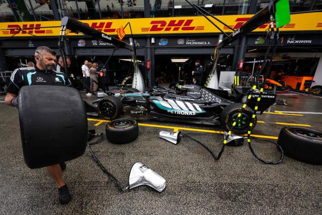 A mechanic holds a tyre next to Mercedes' British driver George Russell car in the pit lane ahead of the Formula One Dutch Grand Prix at The Circuit Zandvoort, western Netherlands, on August 21, 2026. (Photo by JOHN THYS / AFP)