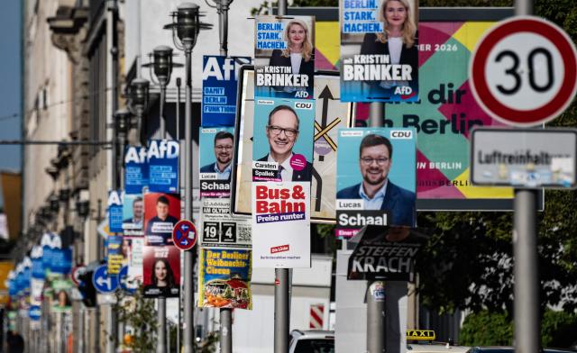 TOPSHOT - Election campaign placards for the upcoming Berlin State elections for the  farright Alternative for Germany party (AfD) (top) and the Christian Democratic Union (CDU) amongst others, hang on lamp posts in Berlin on August 21, 2026. Berlin goes to the polls in regional elections on September 20, 2026. (Photo by John MACDOUGALL / AFP)