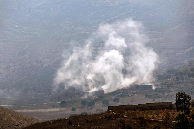 A photograph taken from the southern Lebanese village of Chaqra shows smoke as it rises from houses targeted by Israeli tank shells in the nearby village of Mays al-Jabal on Agust 21, 2026. Hezbollah drew Lebanon into the broader Middle East war in March 2026, with rocket fire at Israel in support of its backer Iran. Israel responded with a heavy air campaign and ground invasion that Lebanese authorities say have killed more than 4,300 people. (Photo by Ammar Ammar / AFP) / 
