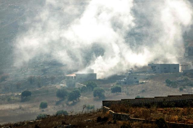 A photograph taken from the southern Lebanese village of Chaqra shows smoke as it rises from houses targeted by Israeli tank shells in the nearby village of Mays al-Jabal on August 21, 2026. Hezbollah drew Lebanon into the broader Middle East war in March 2026, with rocket fire at Israel in support of its backer Iran. Israel responded with a heavy air campaign and ground invasion that Lebanese authorities say have killed more than 4,300 people. (Photo by Ammar Ammar / AFP) / 