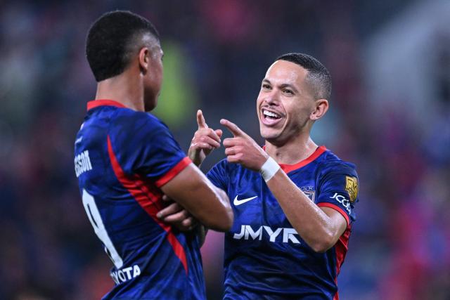 Johor Darul Ta'zim’s Marcos Guilherme Santos Matos (R) celebrates a goal against Kuching City’s during the opening match of the Malaysia Super League season football match between Johor Darul Ta"zaim and Kuching City at the Sultan Ibrahim Stadium in Iskandar Puteri, in Malaysia’s Johor state on August 21, 2026. (Photo by Mohd Rasfan / AFP)