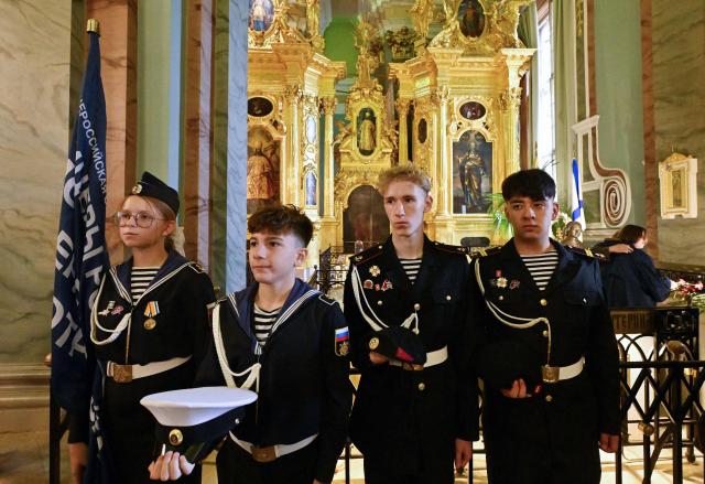 Cadets of the First Cadet Corps attend a ceremony dedicated to Russian Officer's Day at the tomb of Emperor Peter I in the Peter and Paul Cathedral in St. Petersburg on August 21, 2026. (Photo by Olga MALTSEVA / AFP)