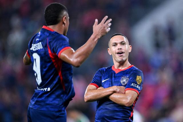Johor Darul Ta'zim’s Marcos Guilherme (R) celebrates after scoring a goal with teammate Bergson Gustavo Silveira Da Silva during the opening football match of the Malaysia Super League between Johor Darul Ta'zim and Kuching City at the Sultan Ibrahim Stadium in Iskandar Puteri, in Malaysia's Johor state on August 21, 2026. (Photo by Mohd RASFAN / AFP)