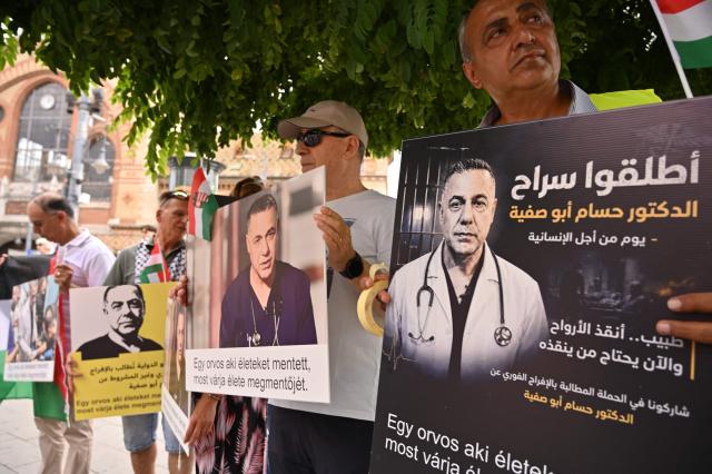 Members and supporters of the Palestinian community take part in a pro-Palestinian demonstration on August 21, 2026 in Budapest, in solidarity with Palestinian physician and director of Gaza's Kamal Adwan hospital Hussam Abu Safiya detained by Israeli forces. Several Jewish organizations criticized both the event and the authorities' decision to allow it, while police stated that they had found no legal grounds to prohibit the gathering. The controversy stems from allegations by Israeli and Jewish organizations that Abu Safiya has links to Hamas and was a member of the organization, while his supporters regard him as a political detainee and reject those accusations. (Photo by Attila KISBENEDEK / AFP)