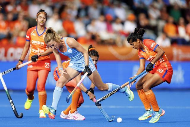 India's Navneet Kaur (L) and Rutuja Pisal (R) fight for the ball with Netherlands' Xan de Waard during the 2026 FIH Women's Hockey World Cup group stage match between The Netherlands and India at the Wagener Stadium in Amstelveen on August 21, 2026. (Photo by Koen van Weel / ANP / AFP) / Netherlands OUT