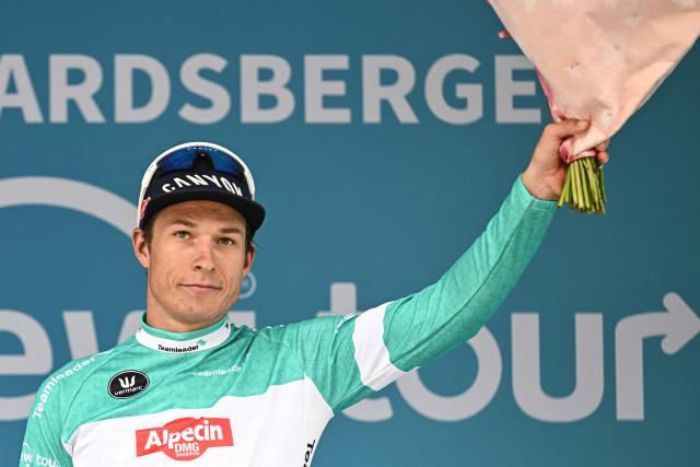 Alpecin-Premier Tech's Belgian rider Jasper Philipsen, leader in the points ranking, celebrates on the podium after arriving second in the stage 3 of the "Renewi Tour" multi-stage cycling race, 182 km from Celles to Geraardsbergen on August 21, 2026. (Photo by DAVID PINTENS / Belga / AFP) / Belgium OUT