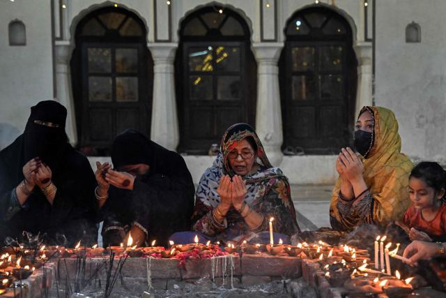 Devotees offer prayers to mark the 'Urs' or death anniversary of the Sufi saint Mian Mir at his shrine in Lahore on August 21, 2026. (Photo by Arif ALI / AFP)