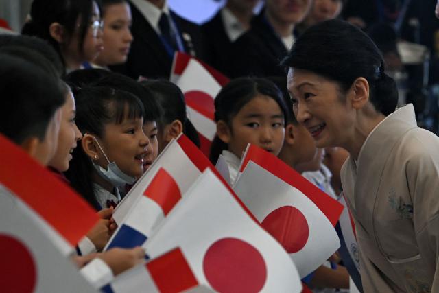 Japan's Crown Princess Kiko bows at children belonging to the Japanese community in Paraguay during the commemoration of the 90th anniversary of the Japanese immigration in the country, at the Conmebol headquarters in Luque, Paraguay, on August 21, 2026. (Photo by DANIEL DUARTE / AFP)