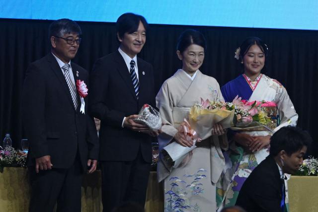 Japan's Crown Prince Akishino (2-L) and Princess Kiko receive presents from the Japanese community in Paraguay during the commemoration of the 90th anniversary of the Japanese immigration in the country, at the Conmebol headquarters in Luque, Paraguay, on August 21, 2026. (Photo by DANIEL DUARTE / AFP)