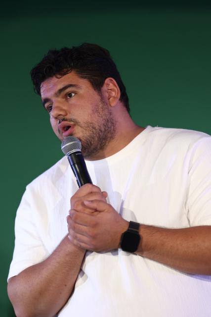 French anti-drug activist and Marseille's deputy mayor Amine Kessaci delivers a speech during the party's "universitй d'йtй" annual summer meeting in Saint-Martin-d’Heres, eastern France, on August 21, 2026. (Photo by Alex MARTIN / AFP)