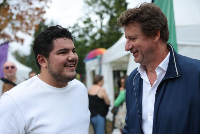French anti-drug activist and Marseille's deputy mayor Amine Kessaci  (L) speaks with French left-wing The Ecologistes party's senator Yannick Jadot during The Ecologistes party's "universitй d'йtй" annual summer meeting in Saint-Martin-d’Heres, eastern France, on August 21, 2026. (Photo by Alex MARTIN / AFP)