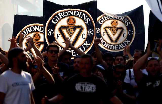 (FILES) Supporters of French 'Nationale 2' fourth-tier club FC Girondins de Bordeaux wave the club’s flags during a protest ahead of a hearing at the Direction Nationale du Controle de Gestion - DNGG, French football financial watchdog, following the six-time French champions' exclusion from national competitions, in Bordeaux, southwestern France July 19, 2026. On August 21, 2026, the Paris Administrative Court confirmed the ban on Girondins de Bordeaux from taking part in national championships, a sanction imposed in July by French sports authorities due to the club’s financial mismanagement, further burying its chances of being saved. (Photo by ROMAIN PERROCHEAU / AFP)