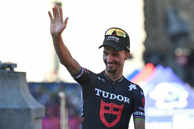 (FILES) Tudor Pro Cycling Team's French rider Julian Alaphilippe waves to spectators on Lille's Grand' Place during the official teams presentation days prior to the start of the 112th edition of the Tour de France cycling race, in Lille, northern France, on July 3, 2025. French rider Julian Alaphilippe, double world champion and winner of Milan–San Remo, officially announced “the end of his sporting career” on August 21, 2026, on his social networks, a statement relayed by his Tudor team. (Photo by Loic VENANCE / AFP)