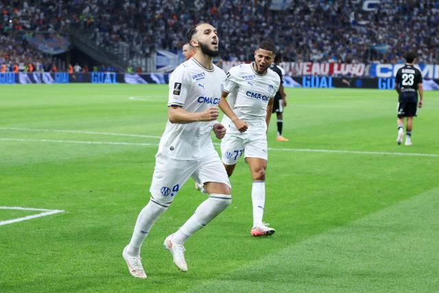 Marseille's Algerian forward #09 Amine Gouiri (L) celebrates after scoring his team's second goal from the penalty spot during the French L1 football match between Olympique de Marseille (OM) and RC Strasbourg Alsace at the Stade Velodrome in Marseille, south-eastern France on August 21, 2026. (Photo by Pascal POCHARD-CASABIANCA / AFP)