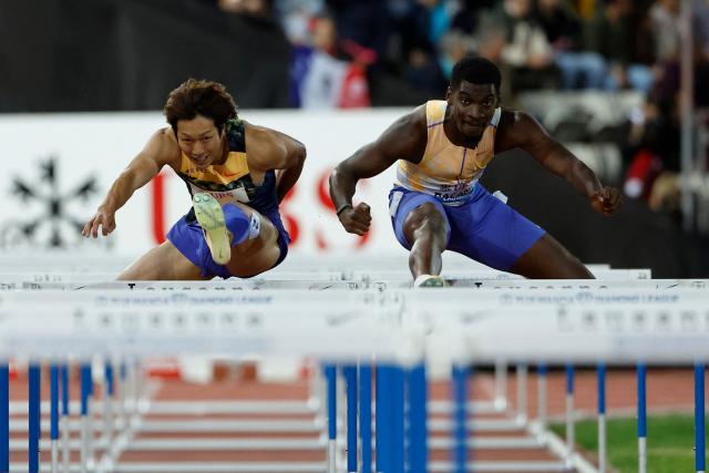 Japan's Shunsuke Izumiya (L) and Belgium's Elie Bacari (R) compete in the men's 110m Hurdles final during the World Athletics Diamond League athletics meeting at the Stade Olympique de la Pontaise in Lausanne, on August 21, 2026. (Photo by Stefan Wermuth / AFP)