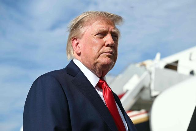 US President Donald Trump looks on as he speaks to reporters before boarding Air Force One at Joint Base Andrews, Maryland on August 21, 2026. Trump is headed to Myrtle Beach, South Carolina to attend a campaign rally for US Senator Darline Graham. (Photo by SAUL LOEB / AFP)
