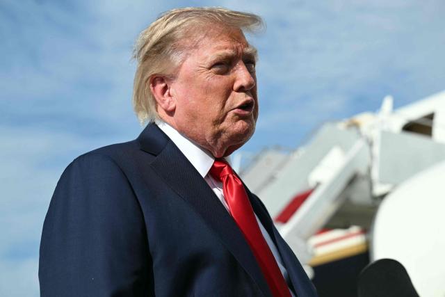 US President Donald Trump speaks to reporters before boarding Air Force One at Joint Base Andrews, Maryland on August 21, 2026. Trump is headed to Myrtle Beach, South Carolina to attend a campaign rally for US Senator Darline Graham. (Photo by SAUL LOEB / AFP)