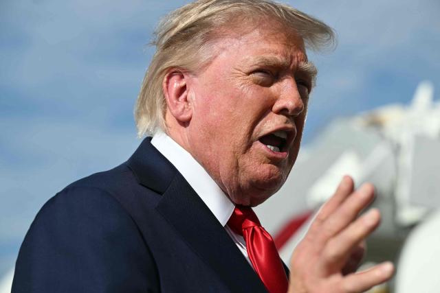 US President Donald Trump gestures as he speaks to reporters before boarding Air Force One at Joint Base Andrews, Maryland on August 21, 2026. Trump is headed to Myrtle Beach, South Carolina to attend a campaign rally for US Senator Darline Graham. (Photo by SAUL LOEB / AFP)