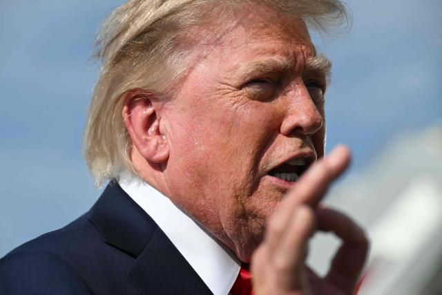 US President Donald Trump gestures as he speaks to reporters before boarding Air Force One at Joint Base Andrews, Maryland on August 21, 2026. Trump is headed to Myrtle Beach, South Carolina to attend a campaign rally for US Senator Darline Graham. (Photo by SAUL LOEB / AFP)