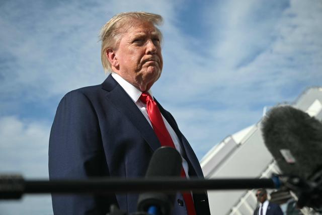 US President Donald Trump speaks to reporters before boarding Air Force One at Joint Base Andrews, Maryland on August 21, 2026. Trump is headed to Myrtle Beach, South Carolina to attend a campaign rally for US Senator Darline Graham. (Photo by SAUL LOEB / AFP)