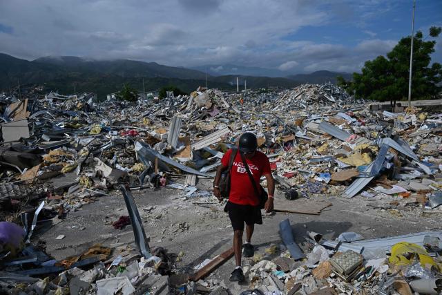 A man walks among the rubble of a destroyed structure in Catia La Mar, La Guaira state, Venezuela, on August 21, 2026, two months after earthquakes of magnitudes 7.2 and 7.5 struck the area. (Photo by Federico PARRA / AFP)