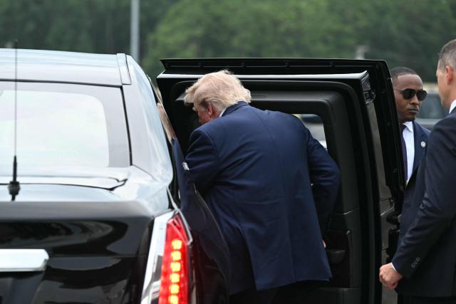 US President Donald Trump enters a waiting vehicle after disembarking from Air Force One upon arrival at Myrtle Beach International Airport in Myrtle Beach, South Carolina, on August 21, 2026. Trump is traveling to attend a campaign rally for US Senator Darline Graham. (Photo by SAUL LOEB / AFP)