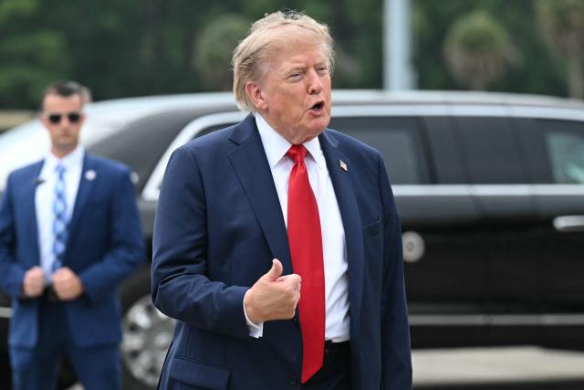 US President Donald Trump gestures as he speaks after disembarking from Air Force One upon arrival at Myrtle Beach International Airport in Myrtle Beach, South Carolina, on August 21, 2026. Trump is traveling to attend a campaign rally for US Senator Darline Graham. (Photo by SAUL LOEB / AFP)