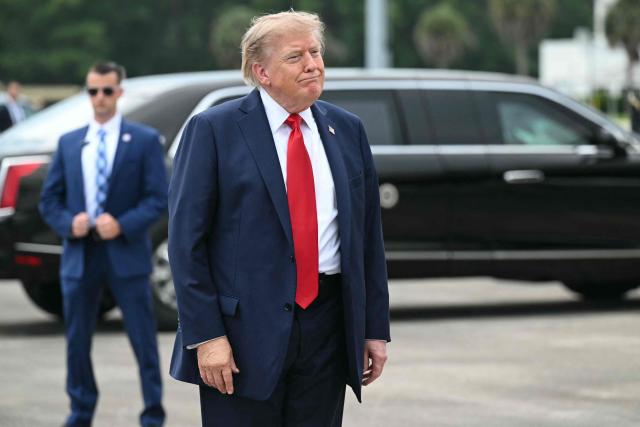 US President Donald Trump looks on after disembarking from Air Force One upon arrival at Myrtle Beach International Airport in Myrtle Beach, South Carolina, on August 21, 2026. Trump is traveling to attend a campaign rally for US Senator Darline Graham. (Photo by SAUL LOEB / AFP)