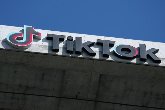 (FILES) The TikTok logo is displayed on signage outside TikTok social media app company offices in Culver City, California on September 30, 2025. TikTok has agreed to pay $400 million to settle a lawsuit with the US Department of Justice over claims that the video-sharing platform violated federal children's privacy laws, the department announced on August 21, 2026. (Photo by Patrick T. Fallon / AFP)