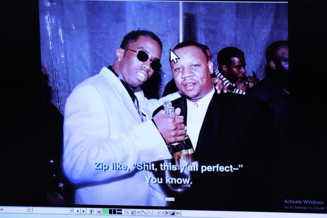 A photograph of US rapper Puff Daddy (L) and Zip Martin, taken at a 1994 New Year's Eve celebration in New York is displayed as evidence during the murder trial of Duane Davis (not pictured), related to the 1996 killing of rapper Tupac Shakur, at Clark County District Court at the Regional Justice Center in Las Vegas, Nevada, on August 21, 2026. The trial of the former gang leader accused of orchestrating the murder of rapper Tupac Shakur began on August 10, 30 years after one of America's most high-profile unresolved killings. The proceedings, expected to last a month, will likely not make clear who fired the shots that killed the California hip-hop legend on the night of September 7, 1996, while he was in Las Vegas to see a Mike Tyson boxing match. (Photo by Bizuayeha TESFAYE / POOL / AFP)