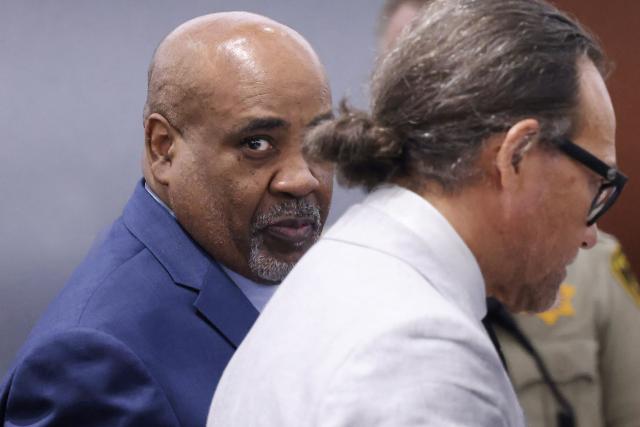 Duane Davis (L) looks on as he appears in court with his attorney Michael Sanft during his murder trial, related to the 1996 killing of rapper Tupac Shakur, at Clark County District Court at the Regional Justice Center in Las Vegas, Nevada, on August 21, 2026. The trial of the former gang leader accused of orchestrating the murder of rapper Tupac Shakur began on August 10, 30 years after one of America's most high-profile unresolved killings. The proceedings, expected to last a month, will likely not make clear who fired the shots that killed the California hip-hop legend on the night of September 7, 1996, while he was in Las Vegas to see a Mike Tyson boxing match. (Photo by Bizuayeha TESFAYE / POOL / AFP)