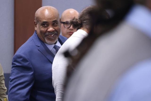 Duane Davis smiles as he looks back during his murder trial, related to the 1996 killing of rapper Tupac Shakur, at Clark County District Court at the Regional Justice Center in Las Vegas, Nevada, on August 21, 2026. The trial of the former gang leader accused of orchestrating the murder of rapper Tupac Shakur began on August 10, 30 years after one of America's most high-profile unresolved killings. The proceedings, expected to last a month, will likely not make clear who fired the shots that killed the California hip-hop legend on the night of September 7, 1996, while he was in Las Vegas to see a Mike Tyson boxing match. (Photo by Bizuayeha TESFAYE / POOL / AFP)