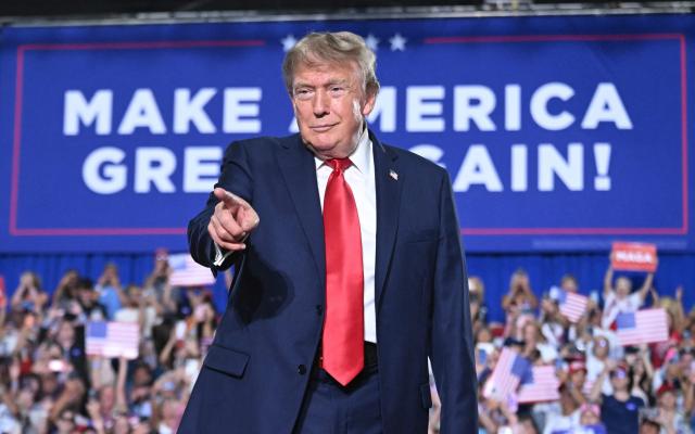 US President Donald Trump points as he arrives to speak during a campaign rally for US Senator Darline Graham at Myrtle Beach Convention Center in Myrtle Beach, South Carolina on August 21, 2026. (Photo by SAUL LOEB / AFP)