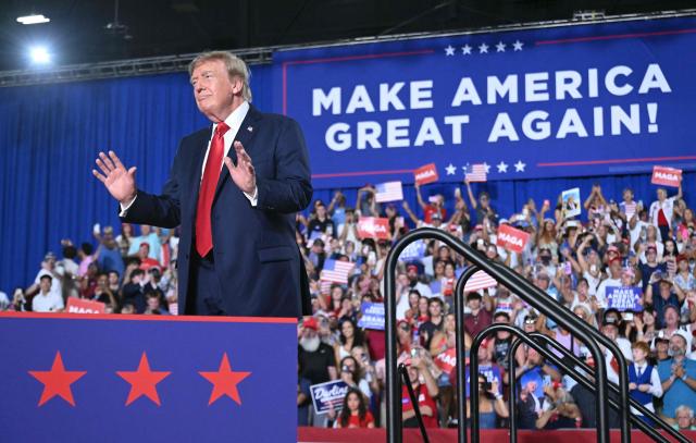 Attendees cheer as US President Donald Trump arrives to speak during a campaign rally for US Senator Darline Graham at Myrtle Beach Convention Center in Myrtle Beach, South Carolina on August 21, 2026. (Photo by SAUL LOEB / AFP)