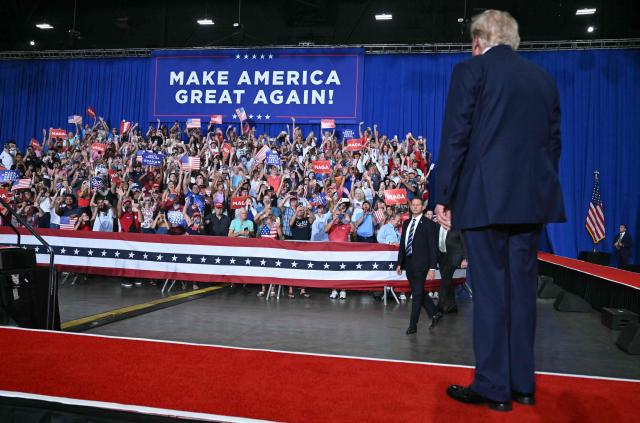 Attendees cheer as US President Donald Trump arrives to speak during a campaign rally for US Senator Darline Graham at Myrtle Beach Convention Center in Myrtle Beach, South Carolina on August 21, 2026. (Photo by SAUL LOEB / AFP)