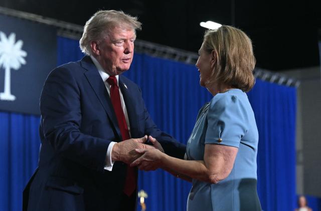 US President Donald Trump speaks with US Senator Darline Graham on stage during a campaign rally for at Myrtle Beach Convention Center in Myrtle Beach, South Carolina on August 21, 2026. (Photo by SAUL LOEB / AFP)