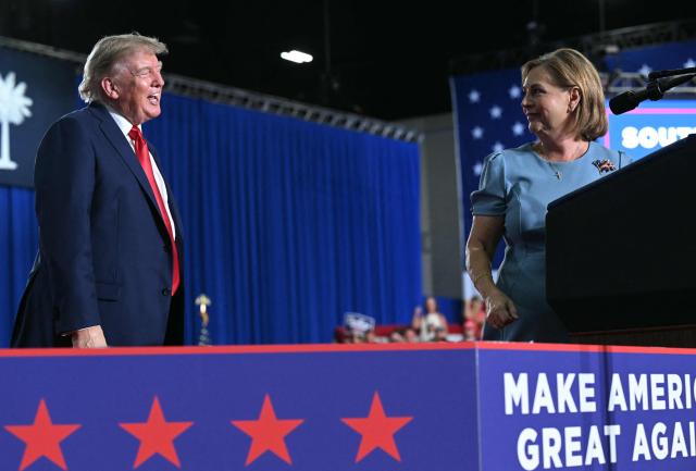US President Donald Trump congratulates US Senator Darline Graham after she spoke during a campaign rally at Myrtle Beach Convention Center in Myrtle Beach, South Carolina on August 21, 2026. (Photo by SAUL LOEB / AFP)