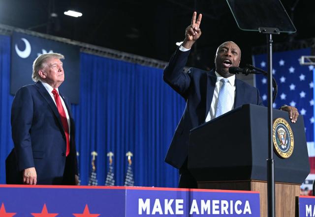 US President Donald Trump listens to US Senator Tim Scott, Republican from South Carolina, speak during a campaign rally for US Senator Darline Graham at Myrtle Beach Convention Center in Myrtle Beach, South Carolina on August 21, 2026. (Photo by SAUL LOEB / AFP)