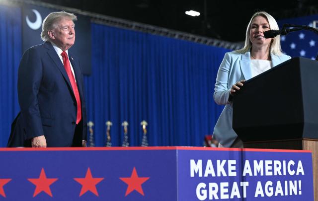 US President Donald Trump listens to White House Press Secretary Karoline Leavitt speak during a campaign rally at Myrtle Beach Convention Center in Myrtle Beach, South Carolina on August 21, 2026. (Photo by SAUL LOEB / AFP)
