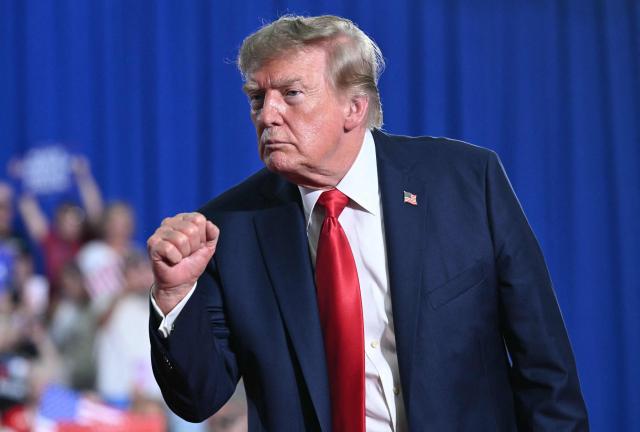 US President Donald Trump clenches his fist after speaking at a campaign rally for US Senator Darline Graham at Myrtle Beach Convention Center in Myrtle Beach, South Carolina on August 21, 2026. (Photo by SAUL LOEB / AFP)
