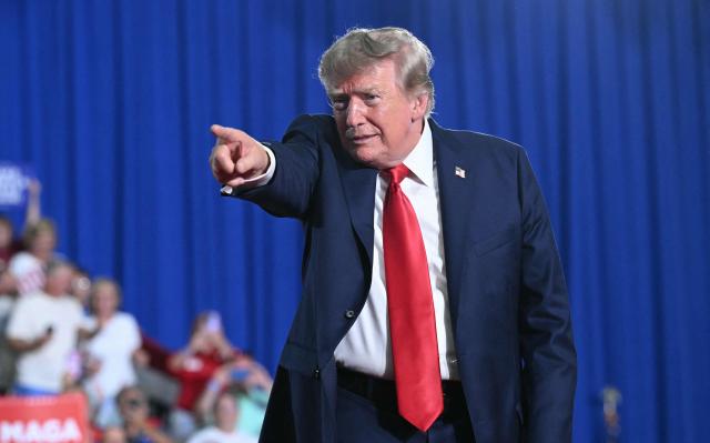 US President Donald Trump points to someone in the crowd after speaking at a campaign rally for US Senator Darline Graham at Myrtle Beach Convention Center in Myrtle Beach, South Carolina on August 21, 2026. (Photo by SAUL LOEB / AFP)