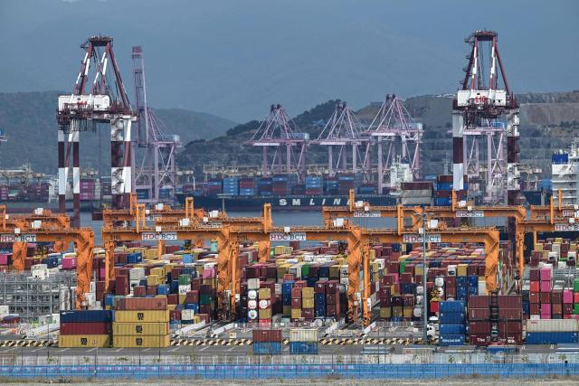 This general view shows shipping containers and cranes at Busan New Port in Busan on August 22, 2026. (Photo by Jung Yeon-je / AFP)