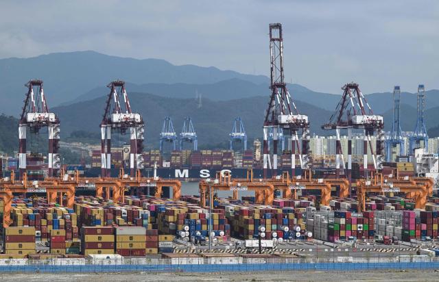 This general view shows shipping containers and cranes at Busan New Port in Busan on August 22, 2026. (Photo by Jung Yeon-je / AFP)