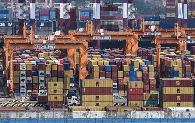 This general view shows shipping containers and cranes at Busan New Port in Busan on August 22, 2026. (Photo by Jung Yeon-je / AFP)
